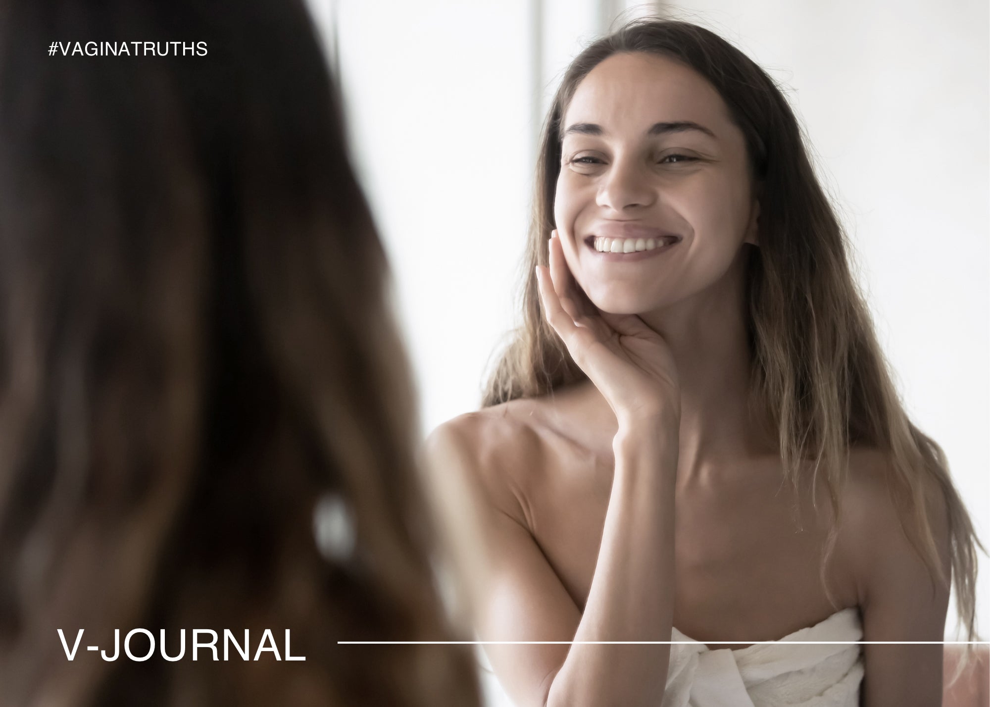 Woman with good skin smiling at herself in the mirror